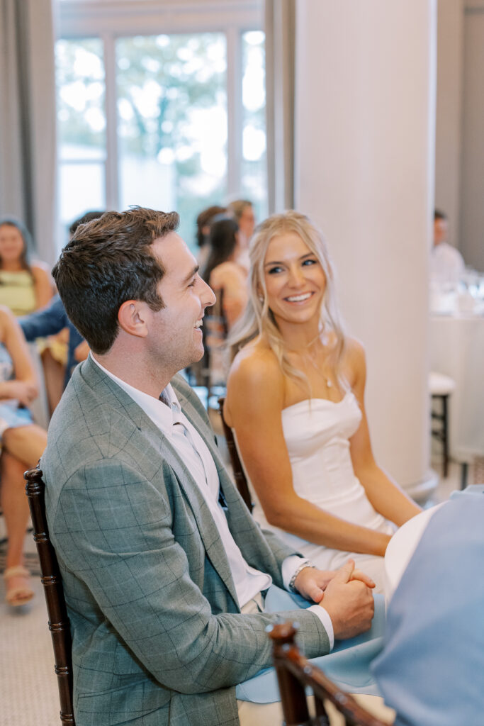 groom laughing with bride smiling
