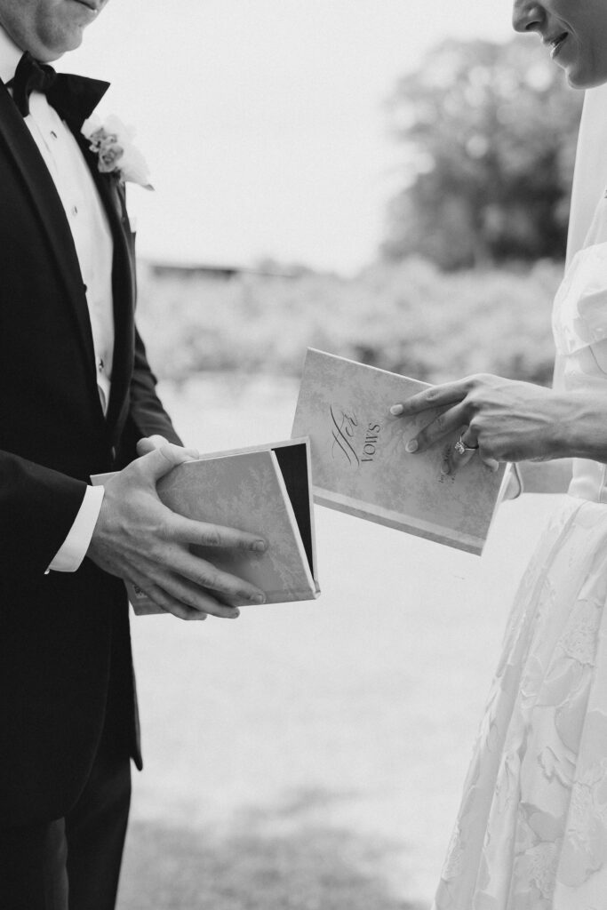 bride and groom reading vow books