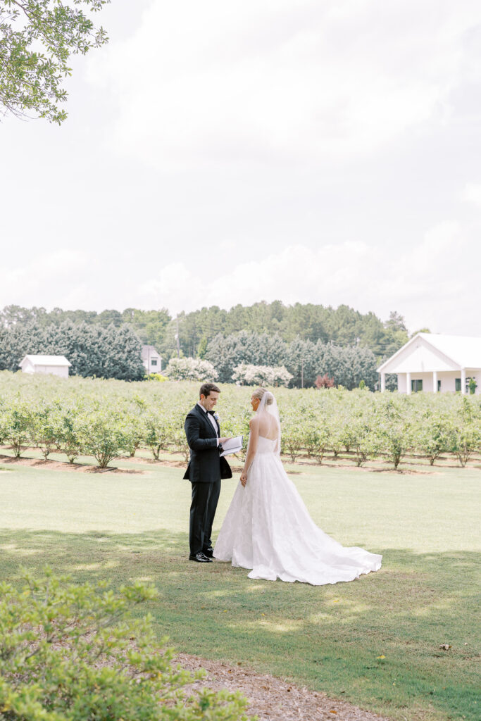 bride and groom reading vow books