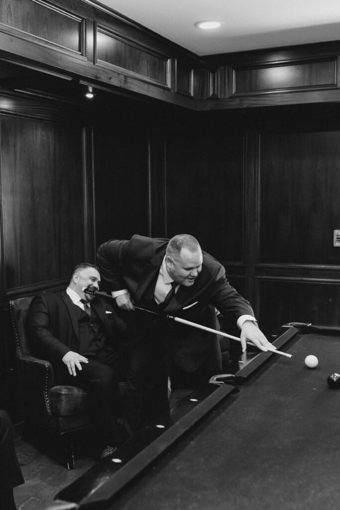 groom playing pool