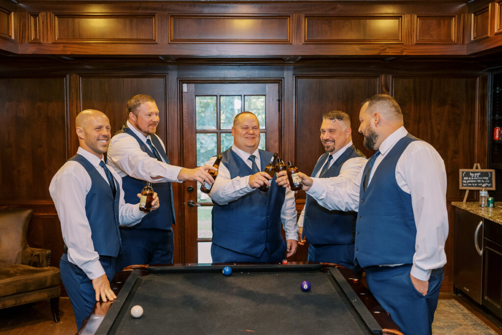 groom and his groomsmen toasting a beer
