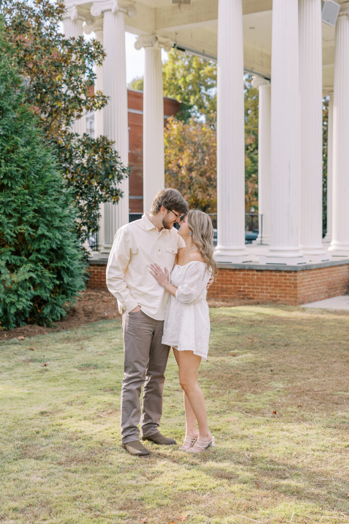 a couple having an engagement session in town park, madison, ga 