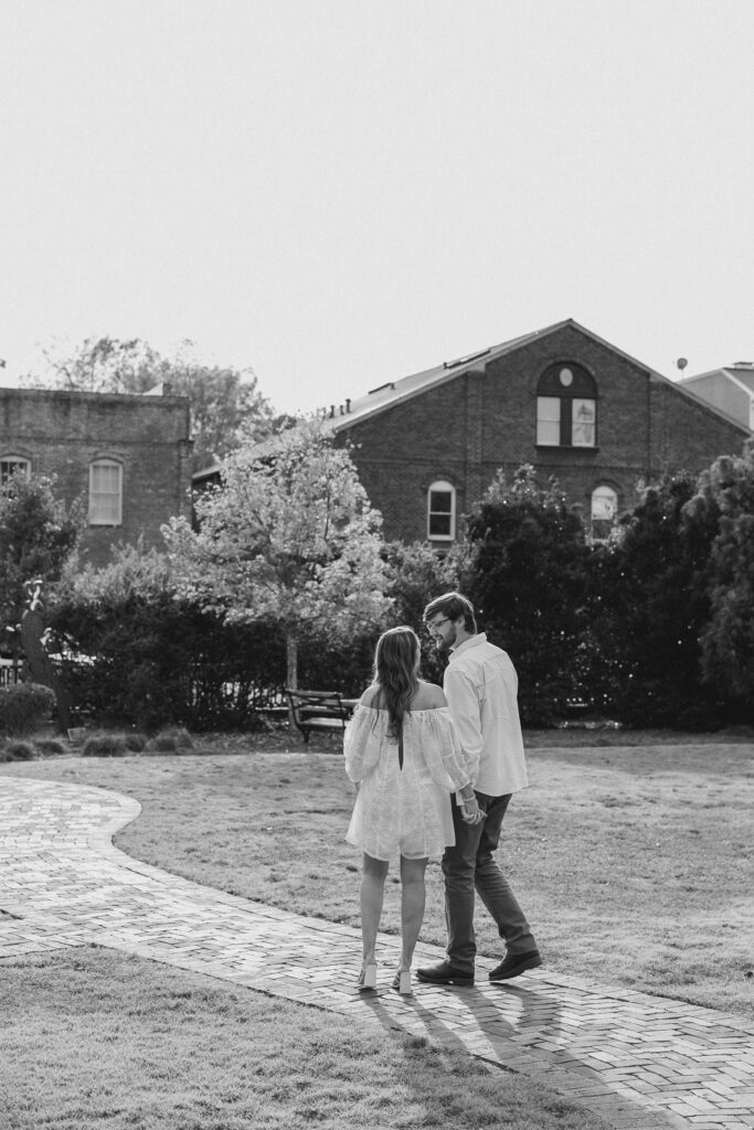 a couple having an engagement session in town park, madison, ga 