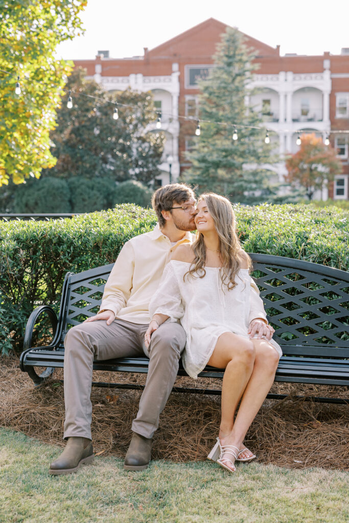 a couple having an engagement session in town park, madison, ga 