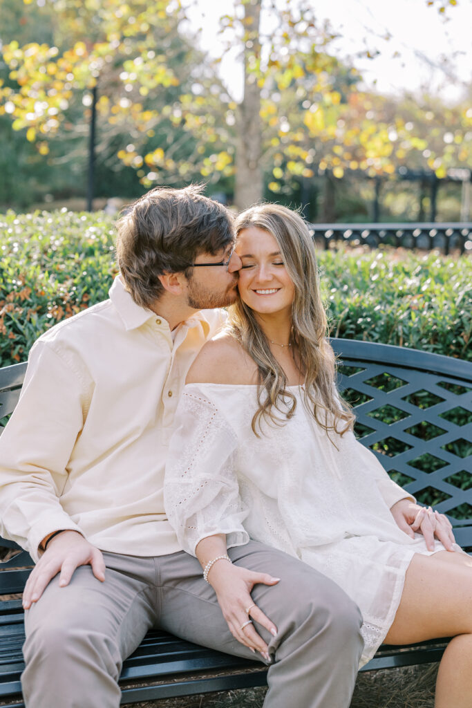 a couple having an engagement session in town park, madison, ga 