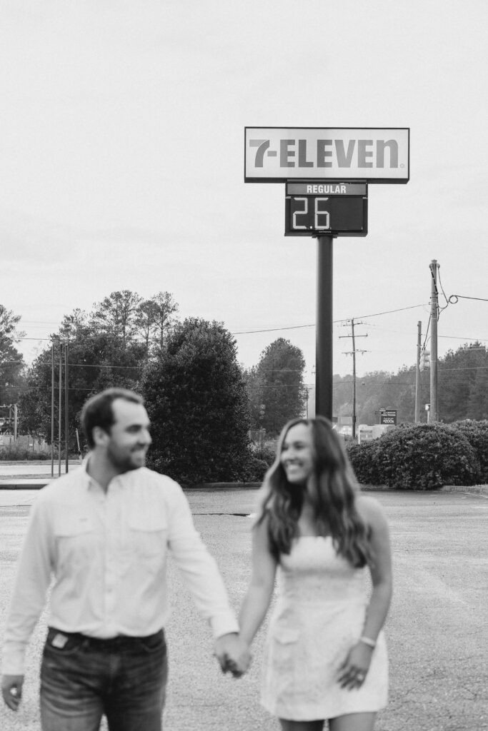 a couple taking a save the date photography session at the 7 Eleven gas station