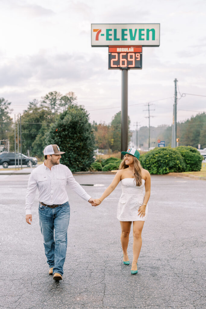 a couple taking a save the date photography session at the 7 Eleven gas station