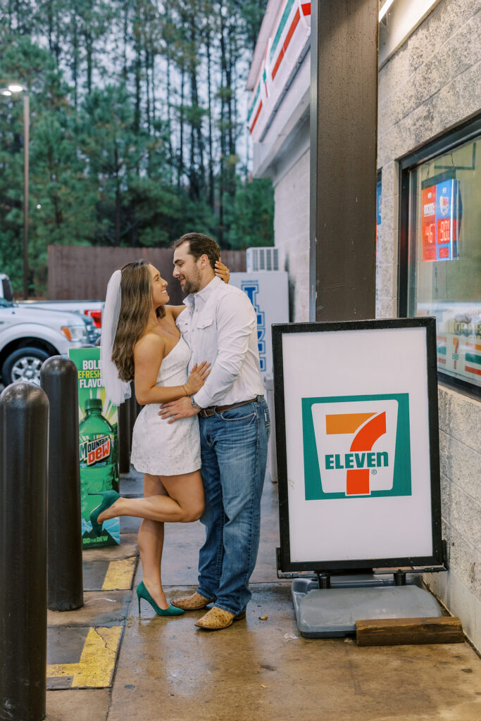 a couple taking a save the date photography session at the 7 Eleven gas station