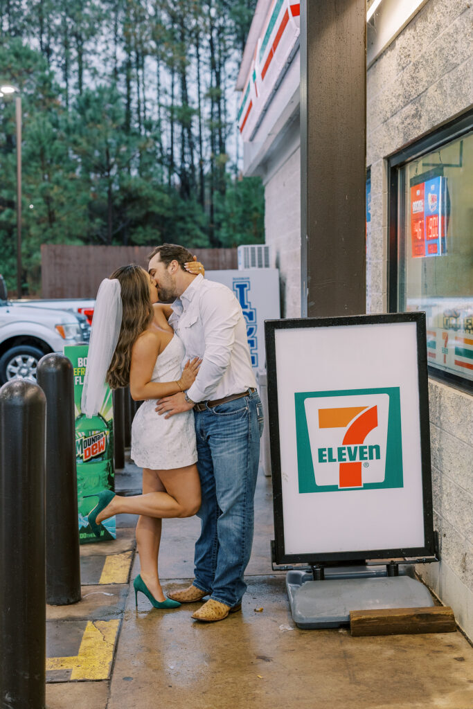 a couple taking a save the date photography session at the 7 Eleven gas station