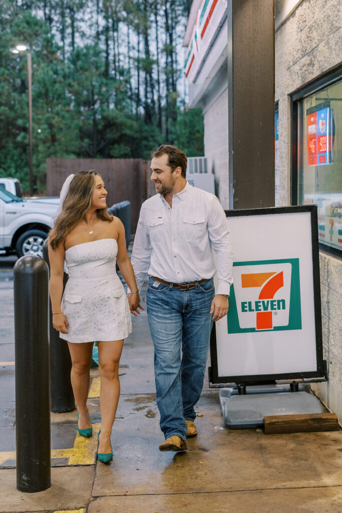 a couple taking a save the date photography session at the 7 Eleven gas station