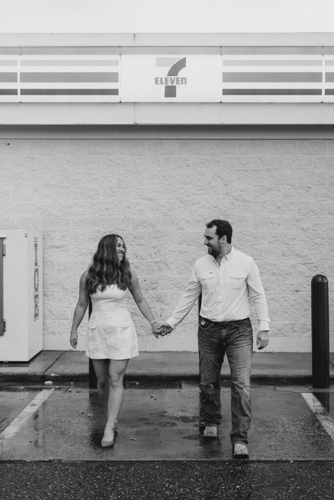 a couple taking a save the date photography session at the 7 Eleven gas station
