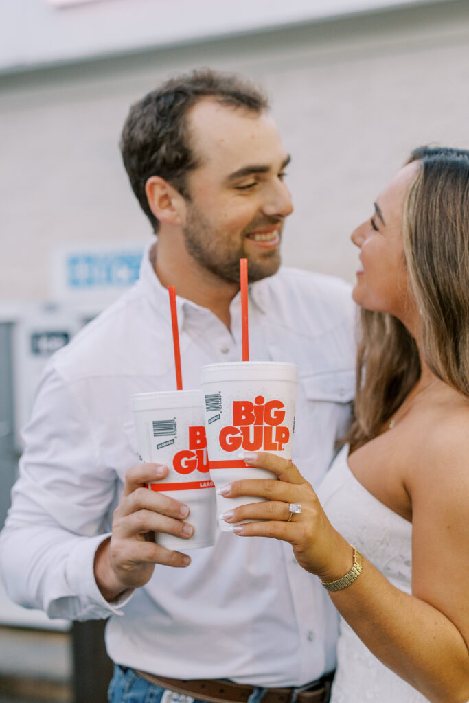 a couple taking a save the date photography session at the 7 Eleven gas station