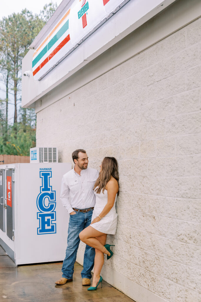 a couple taking a save the date photography session at the 7 Eleven gas station