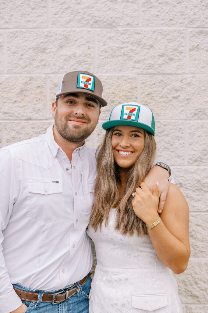 a couple taking a save the date photography session at the 7 Eleven gas station