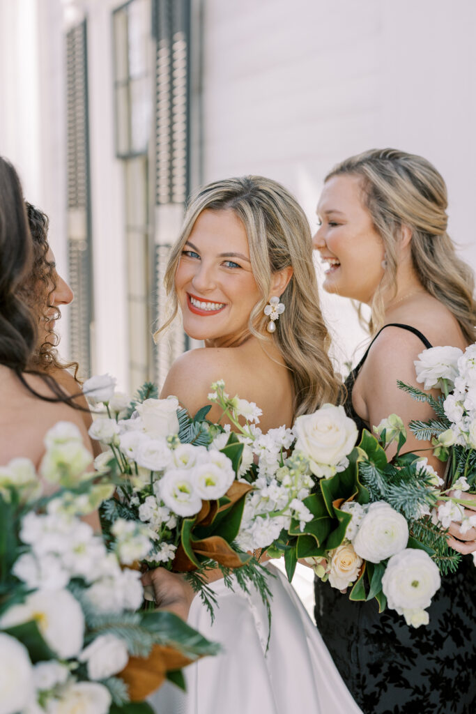 bride with her bridesmaids laughing
