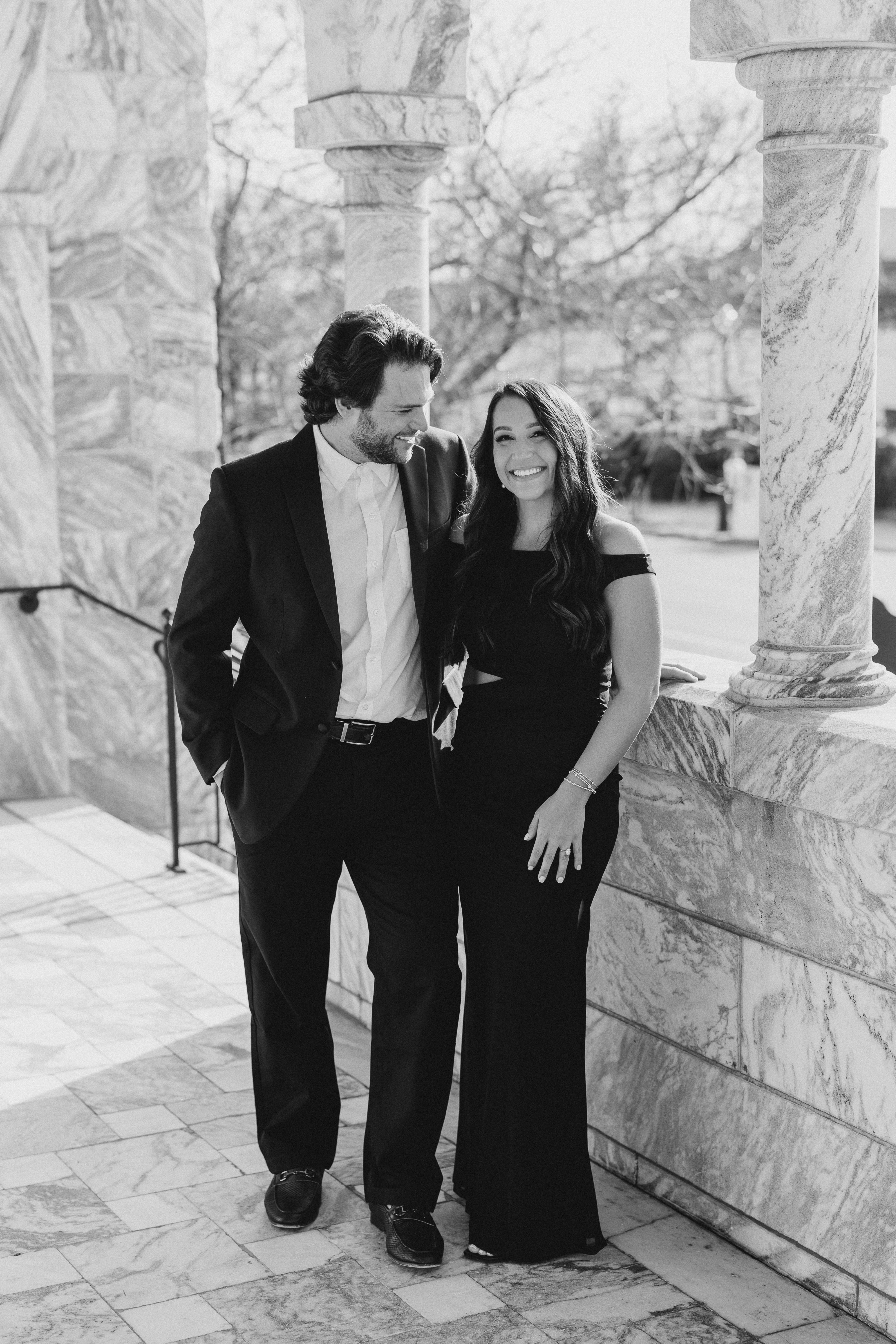 a couple having an engagement photoshoot in marietta square
