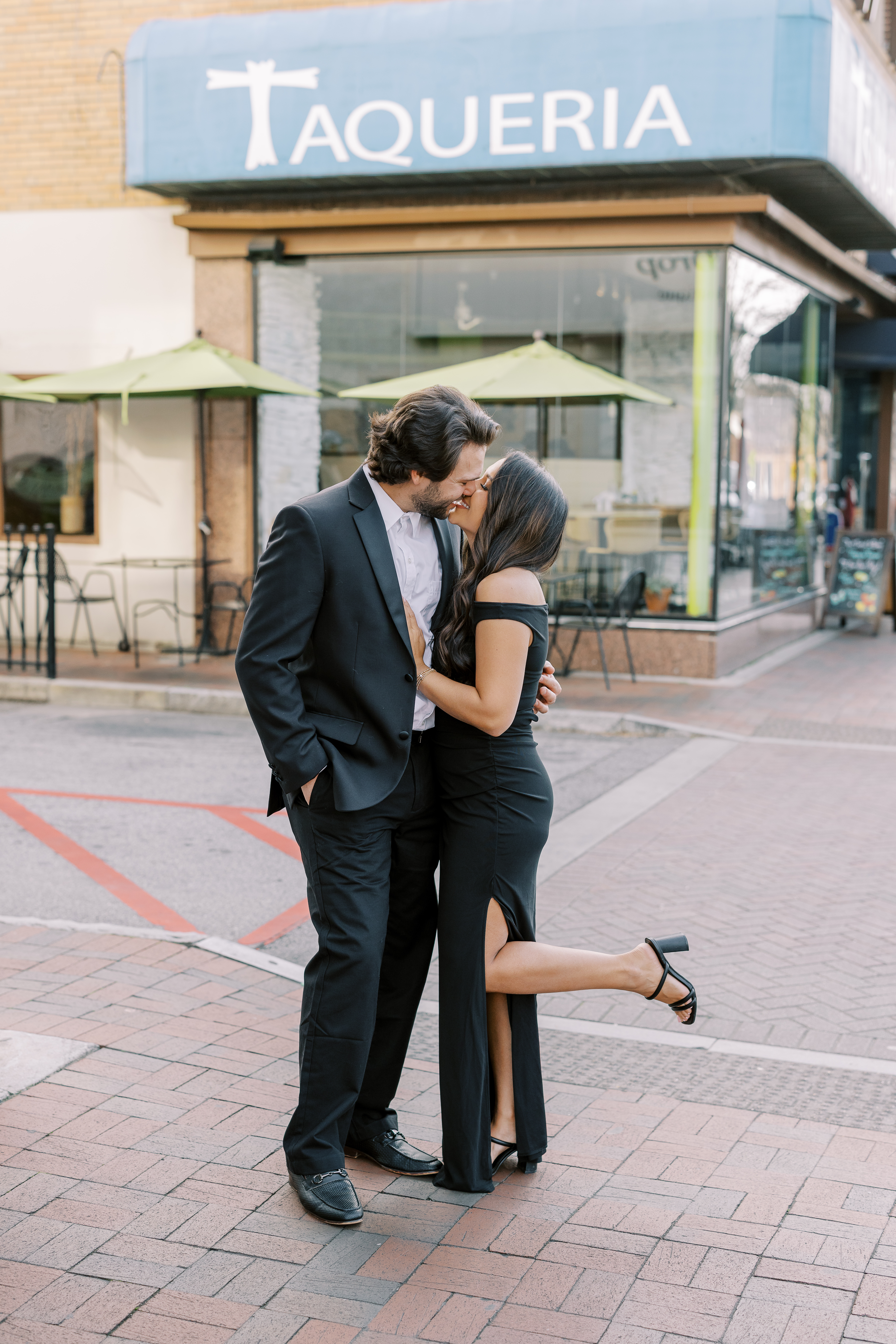 a couple having an engagement photoshoot in marietta square