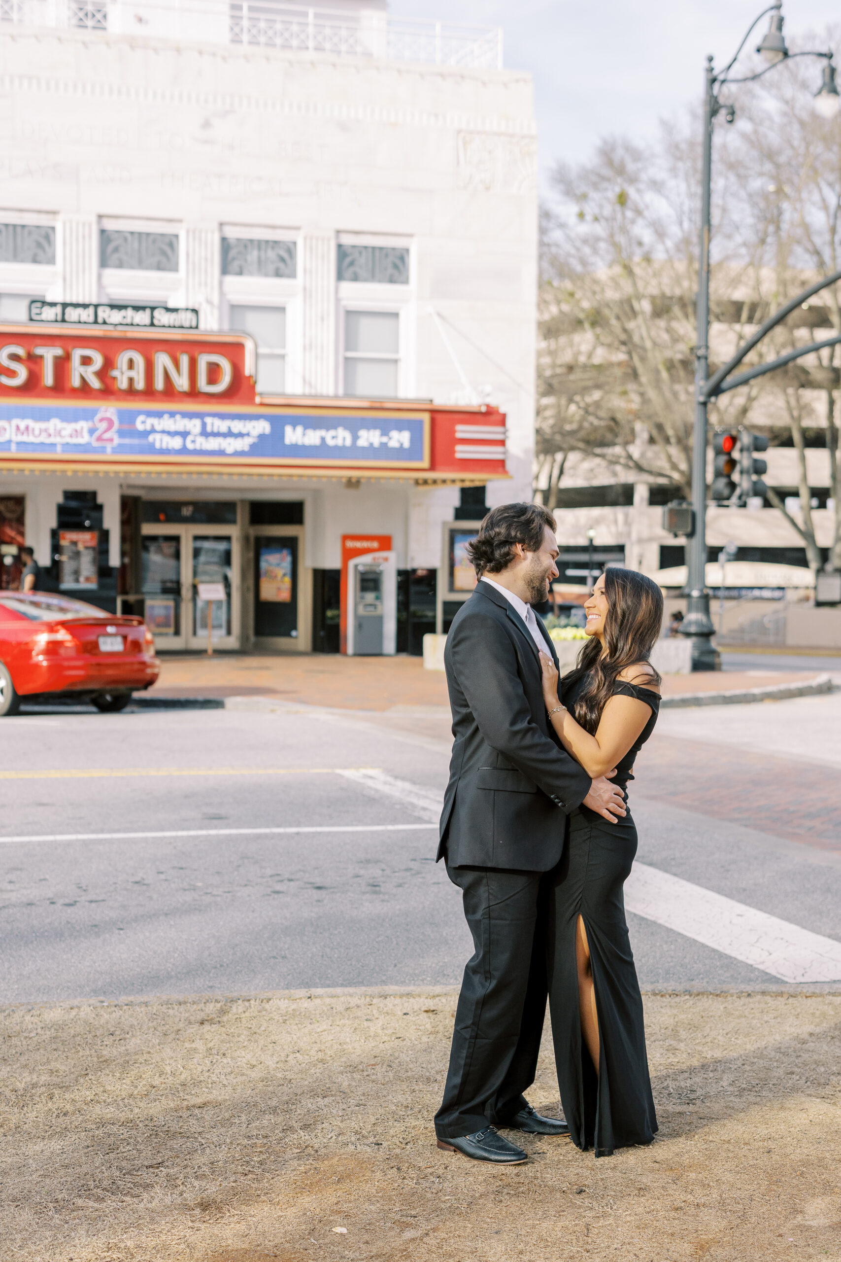 a couple having an engagement photoshoot in marietta square