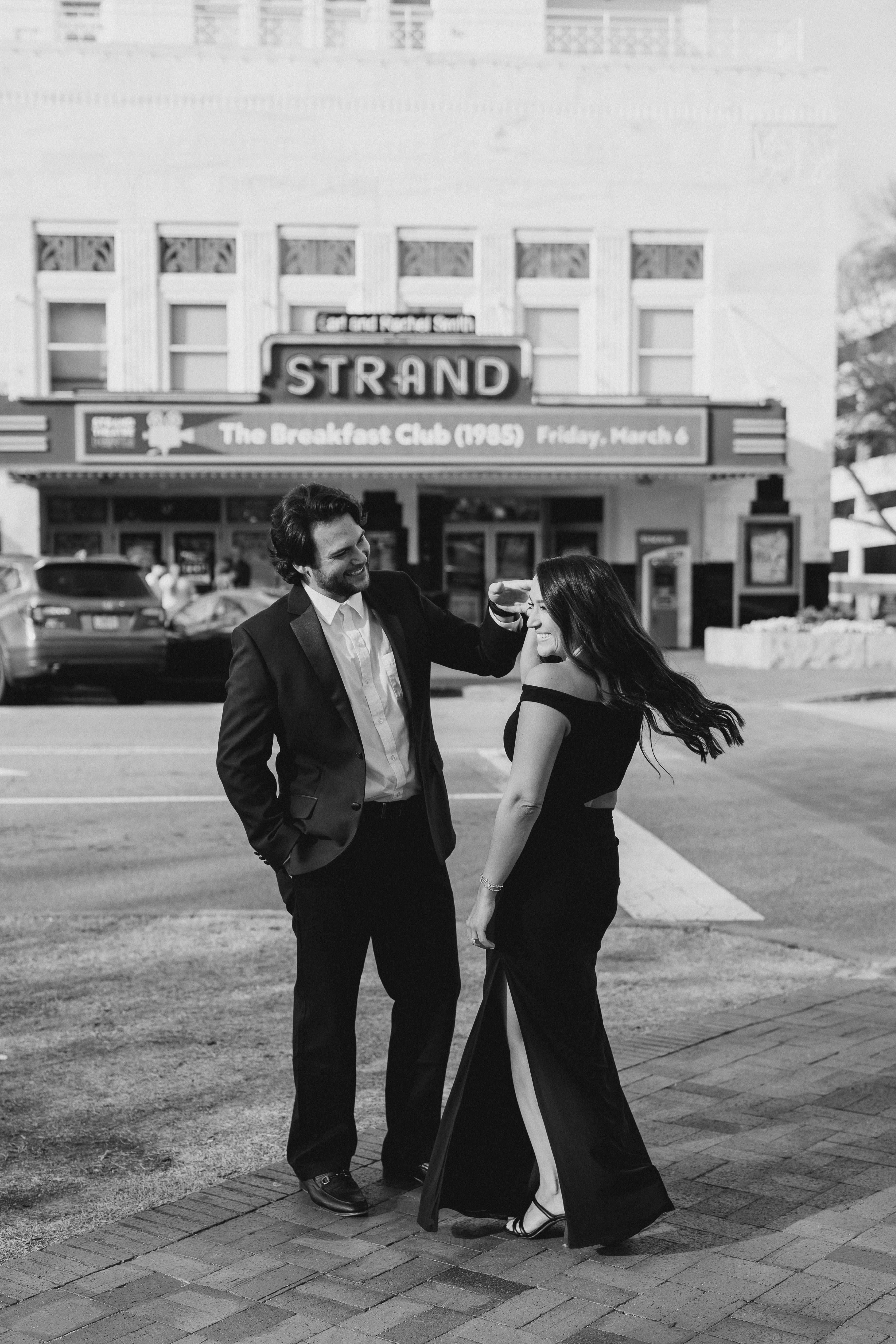 a couple having an engagement photoshoot in marietta square