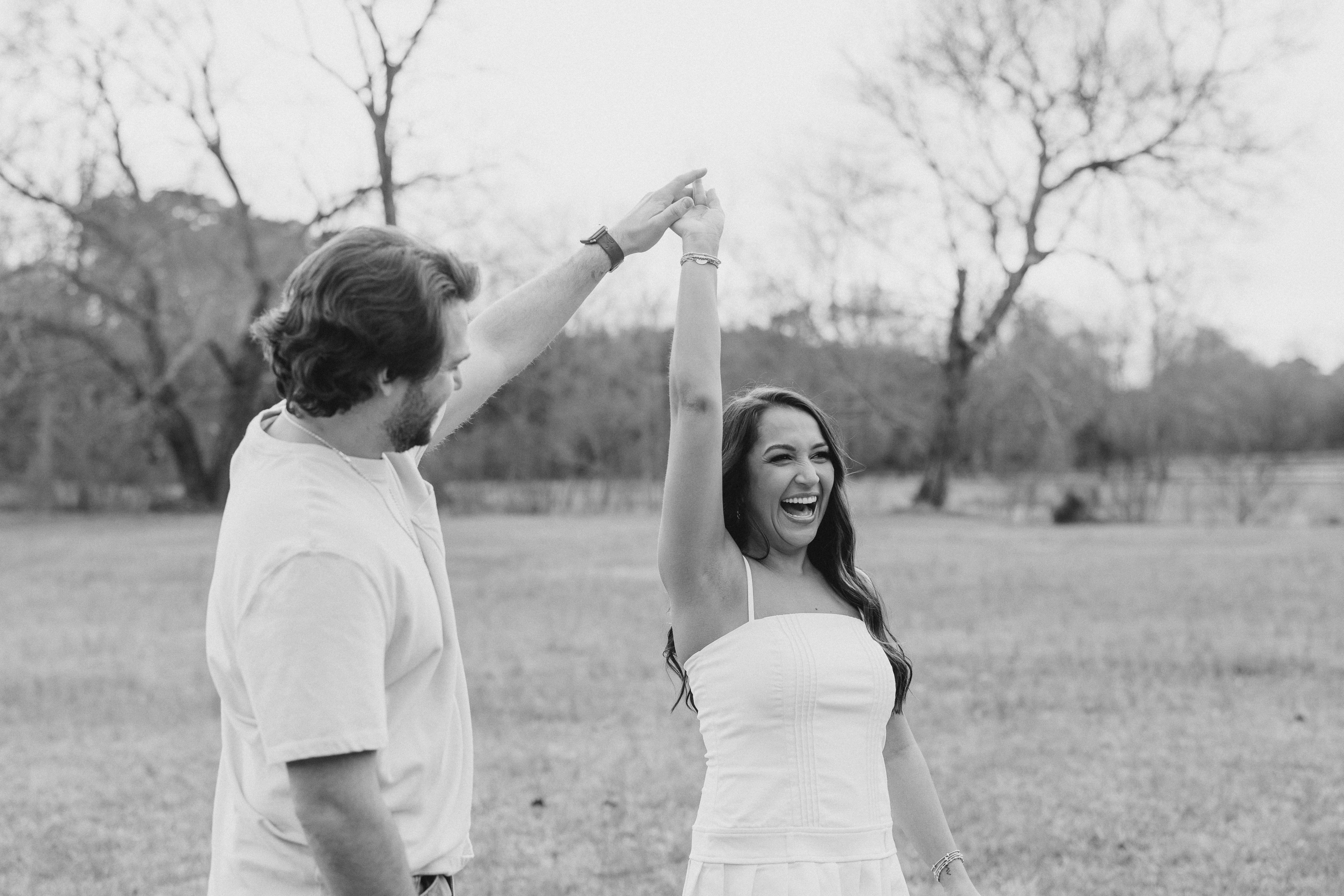a couple having an engagement photoshoot in a field in georgia