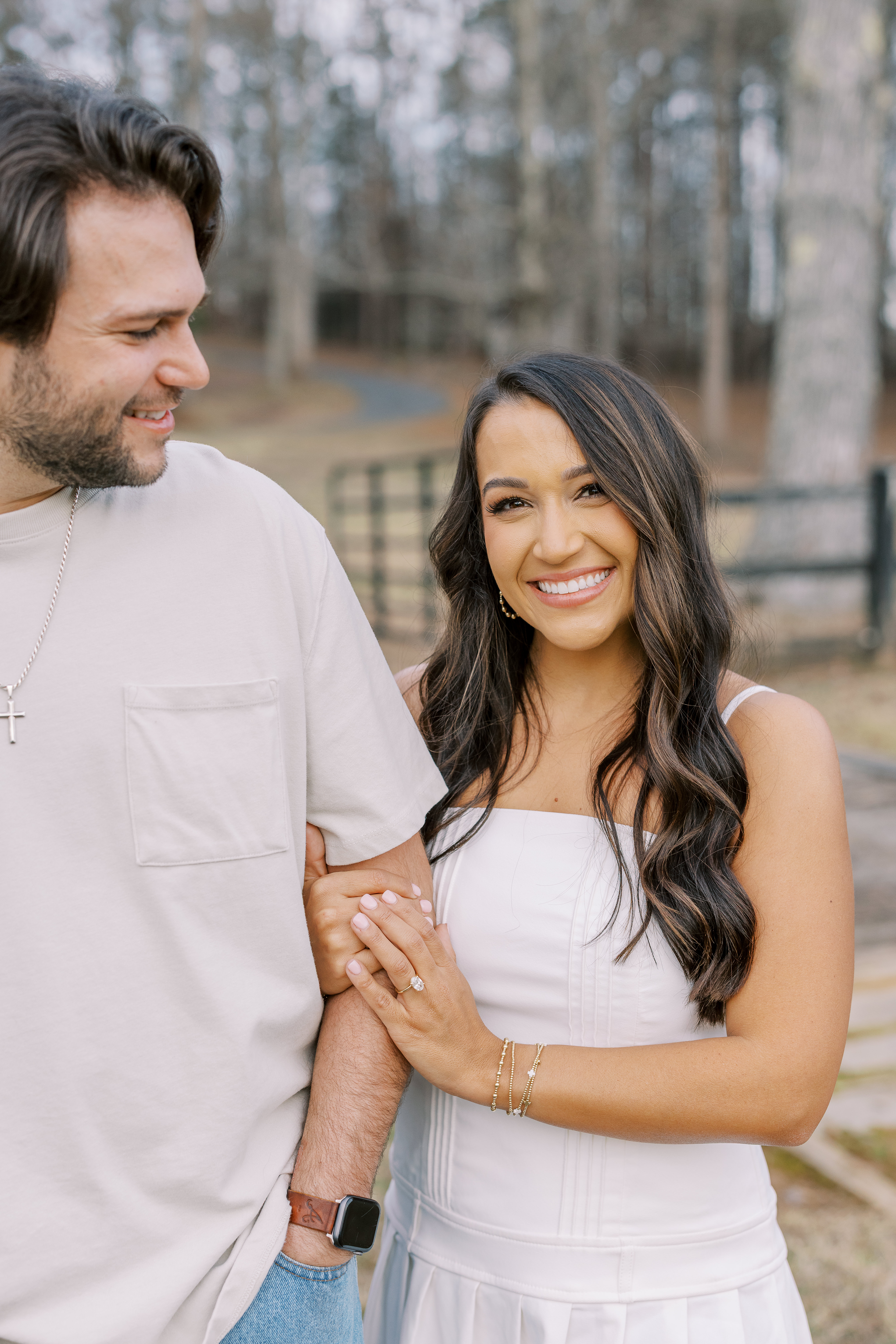 a couple having an engagement photoshoot in a field in georgia