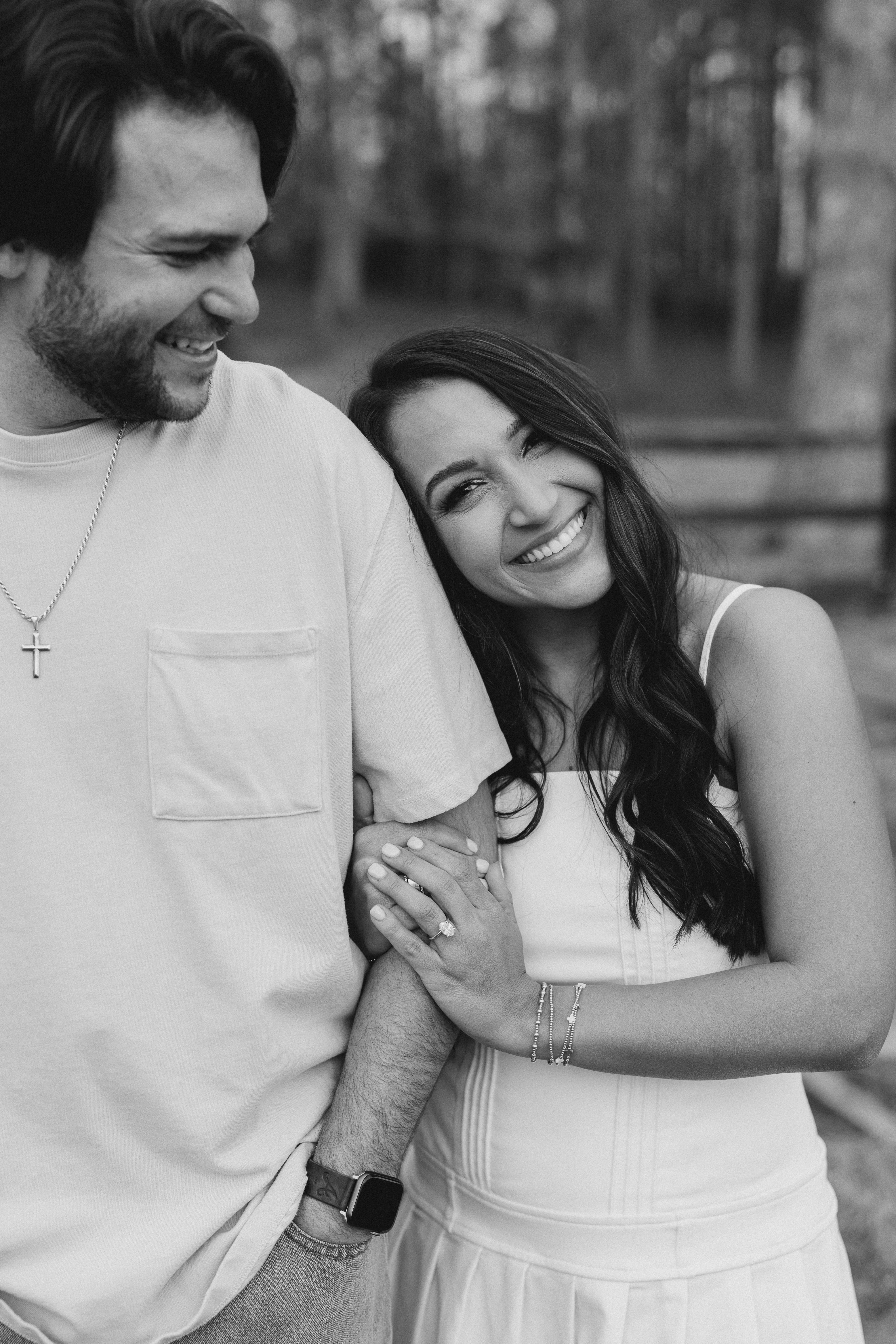a couple having an engagement photoshoot in a field in georgia