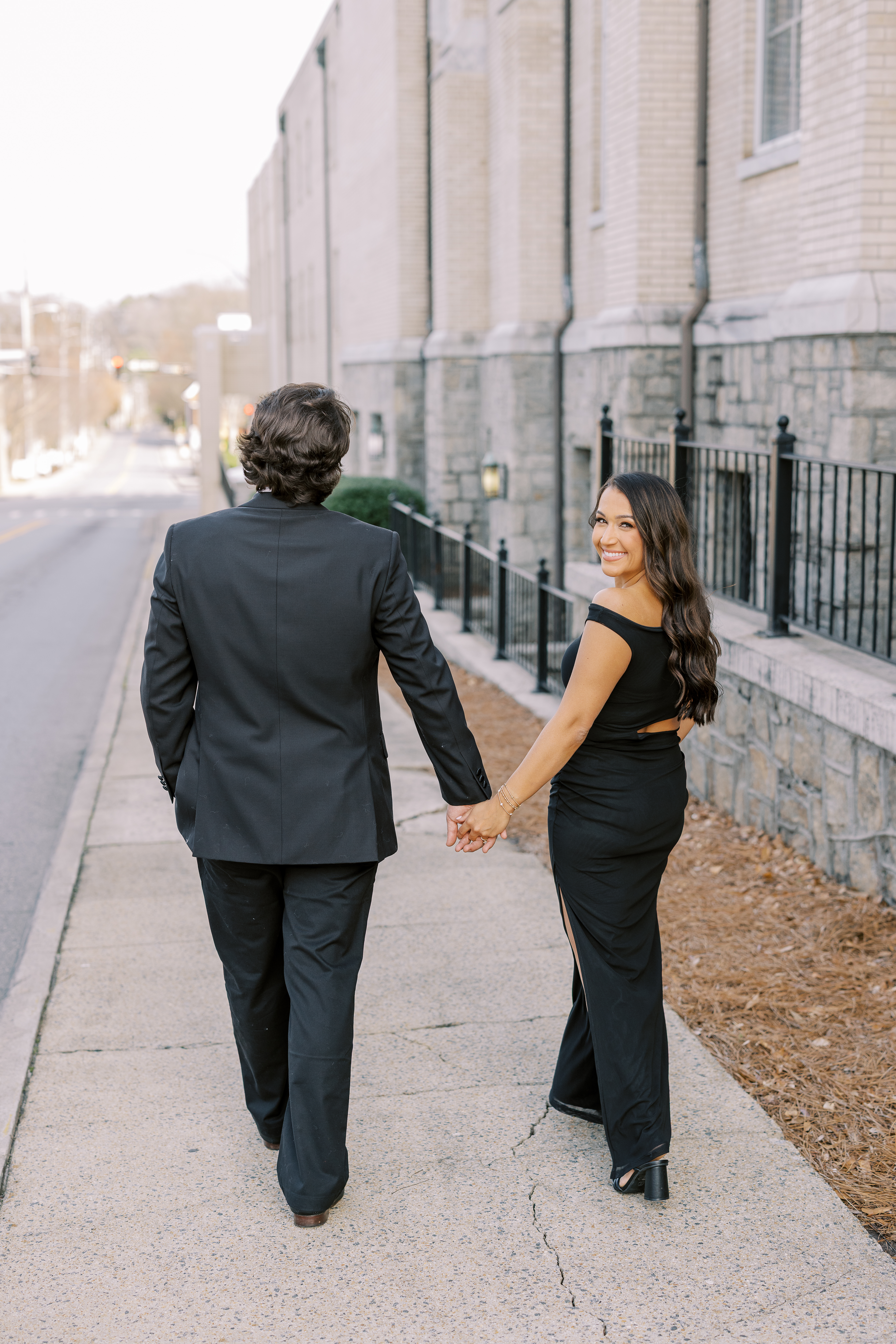 a couple having an engagement photoshoot in marietta square