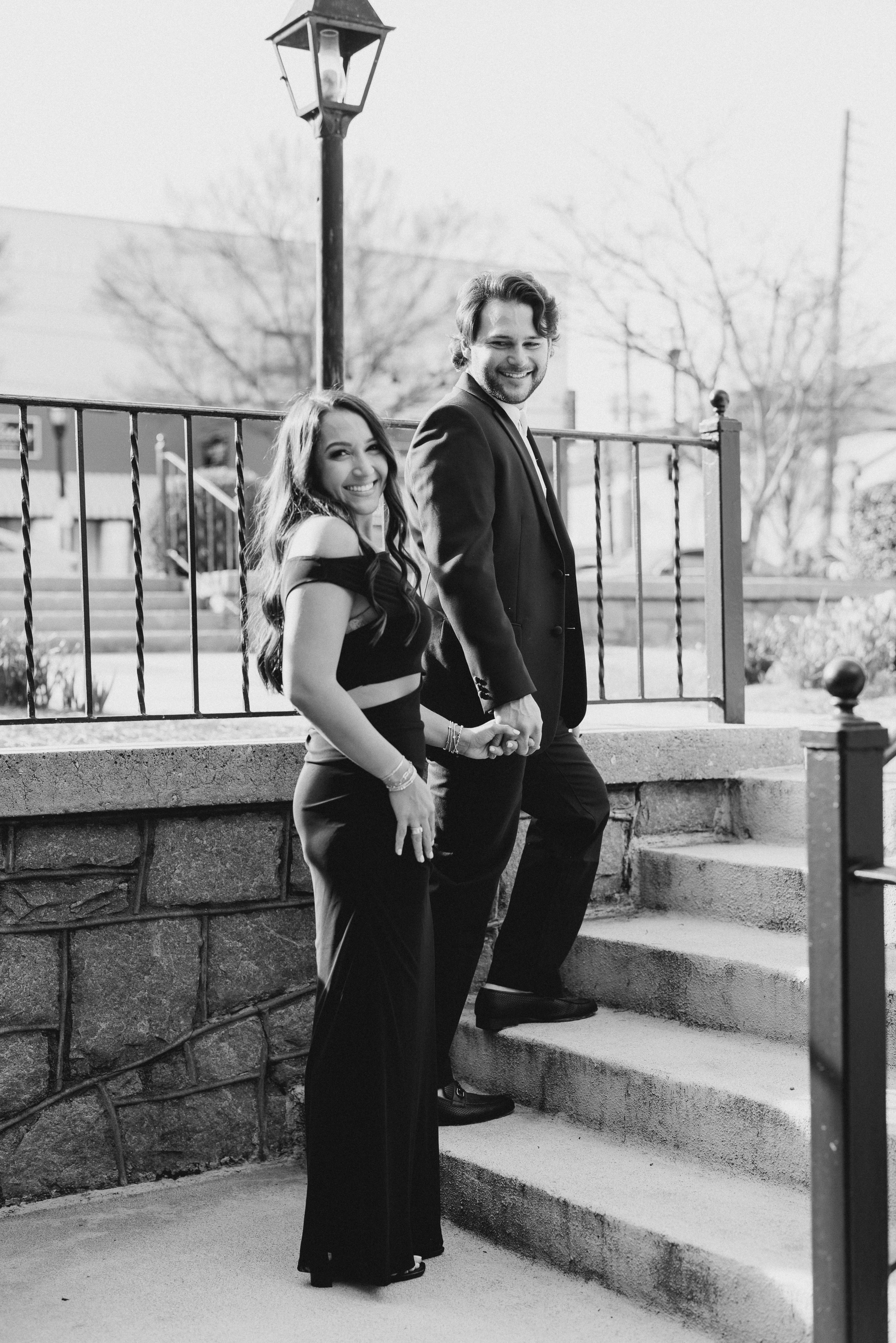 a couple having an engagement photoshoot in marietta square