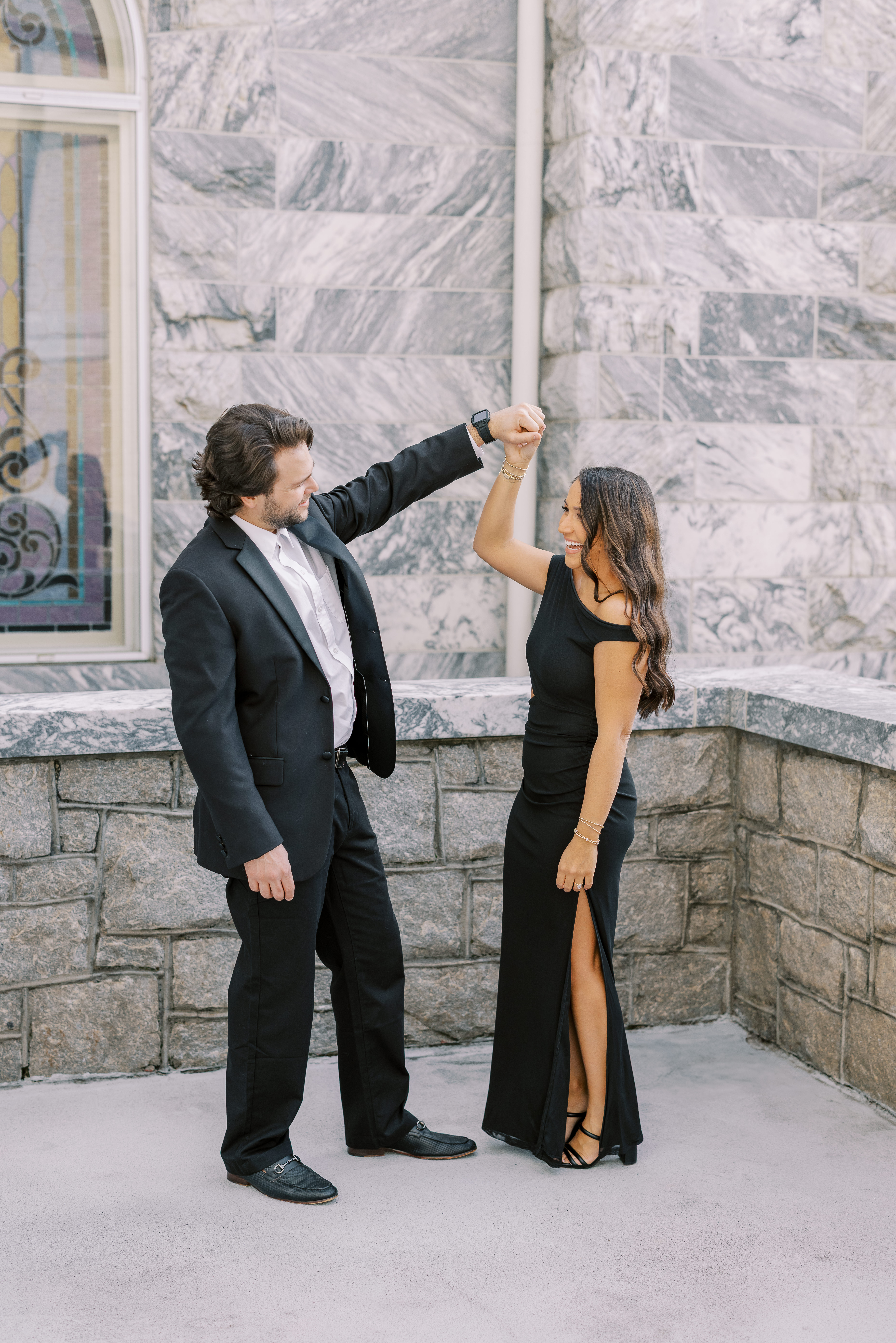 a couple having an engagement photoshoot in marietta square