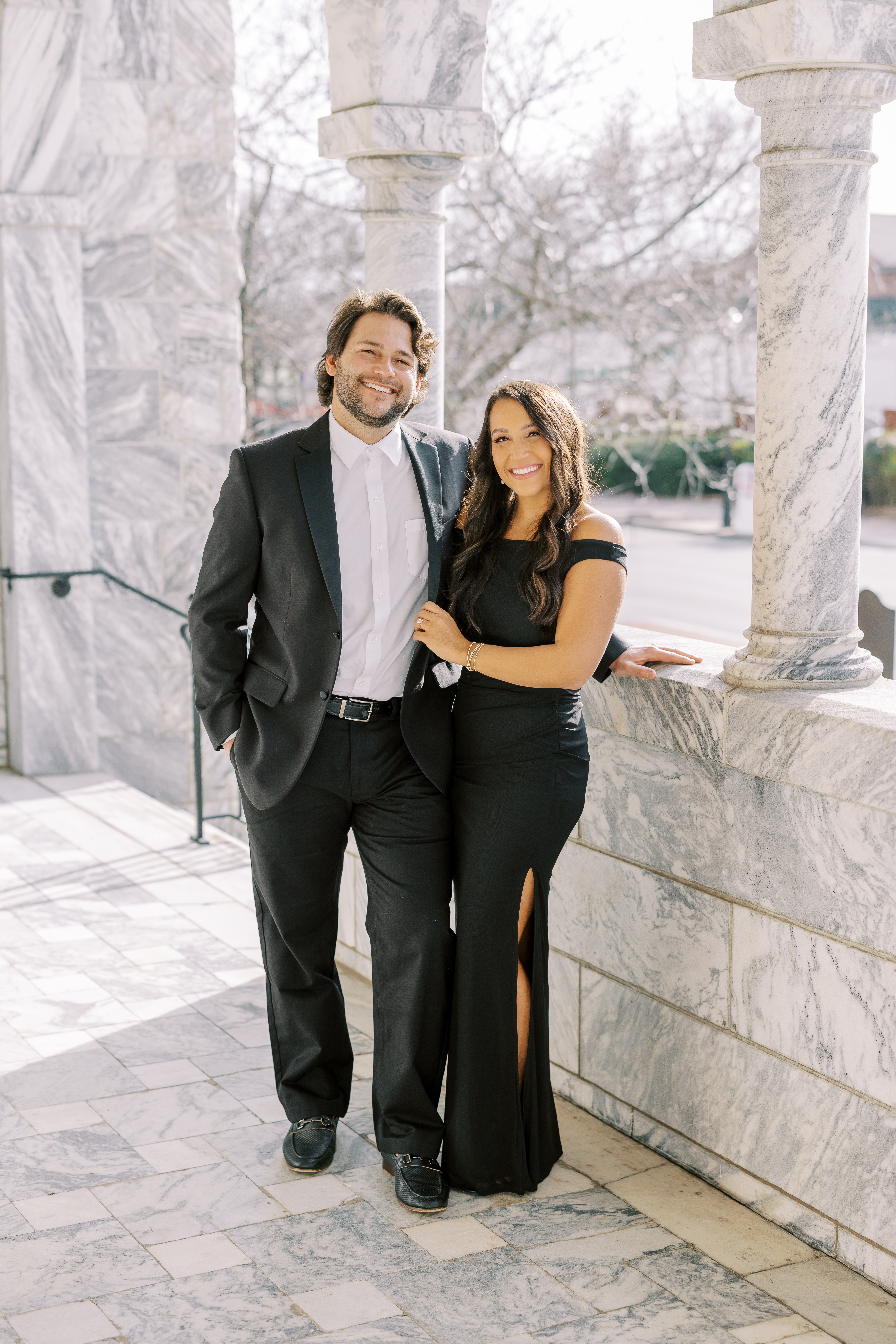 a couple having an engagement photoshoot in marietta square