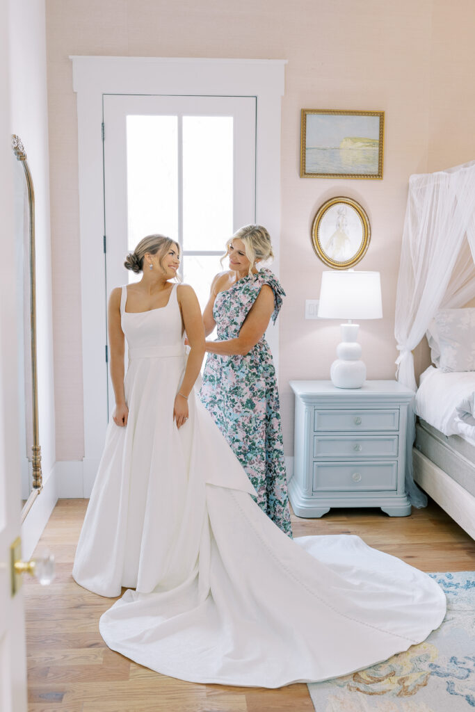 bride's mom helping her get ready