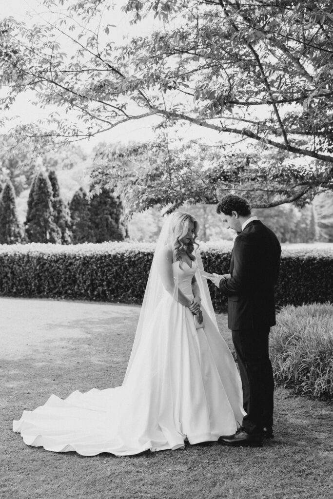 bride and groom reading vows