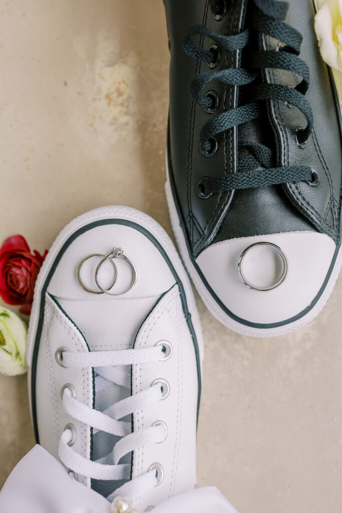 wedding flat lay with converses and rings