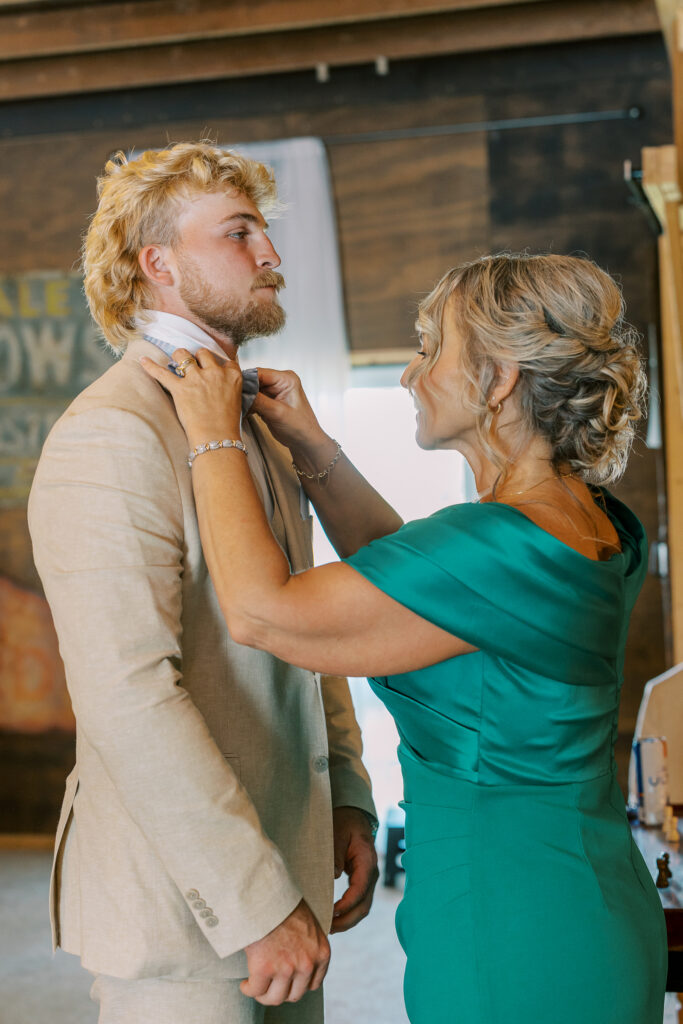 groom being helped by mother with tie